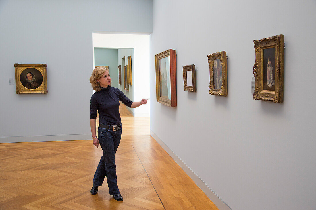 Woman explaining artwork in the Georg Schaefer Museum, Schweinfurt, Franconia, Bavaria, Germany