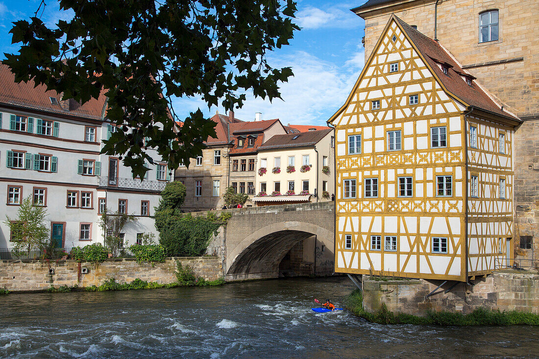 Left branch of the river Regnitz with canoeist and Altes Rathaus city hall building, Bamberg, Franconia, Bavaria, Germany