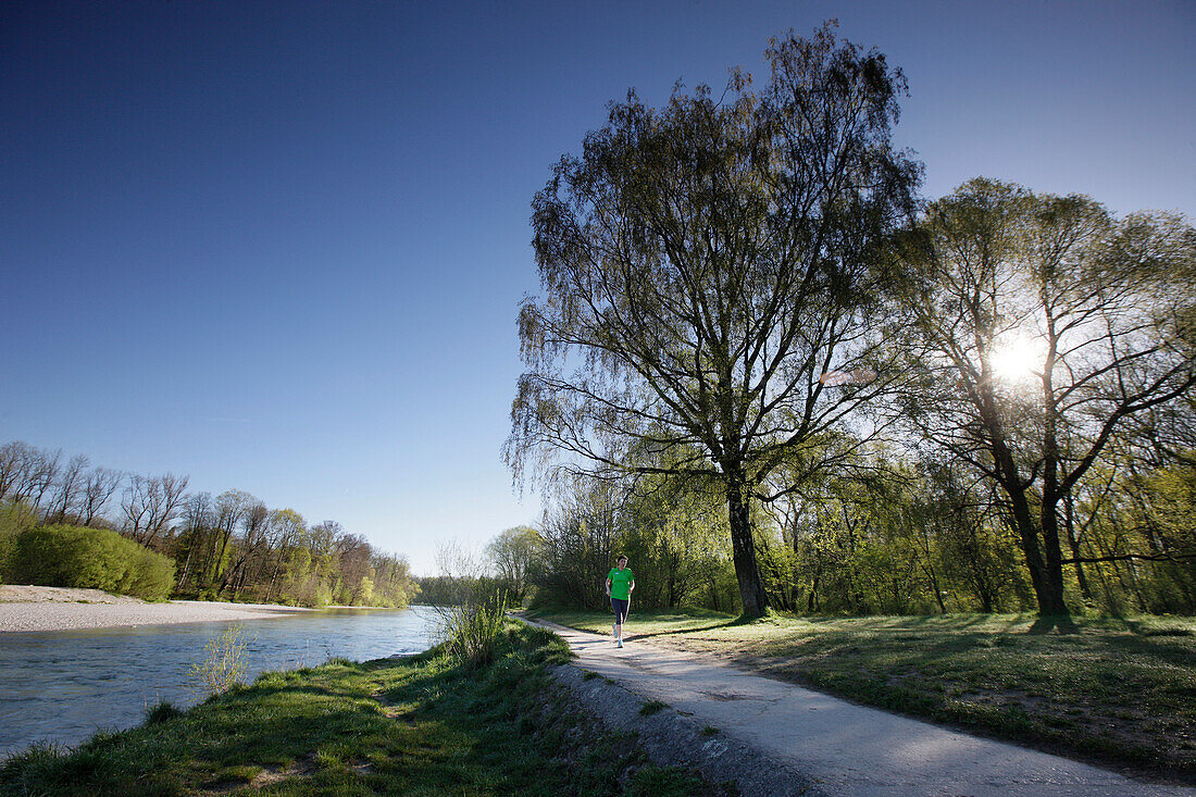 Jogger läuft entlang der Isar am Morgen, Flaucher, München, Bayern, Deutschland