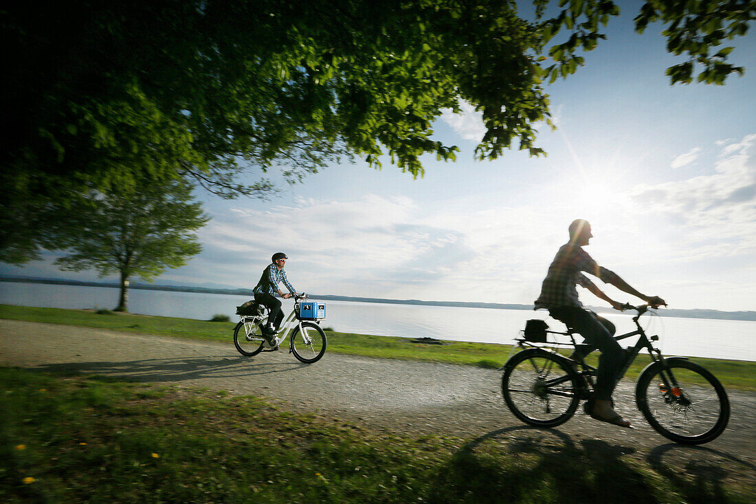 Man cycling with an E-bike along lake Starnberg, Upper Bavaria, Germany