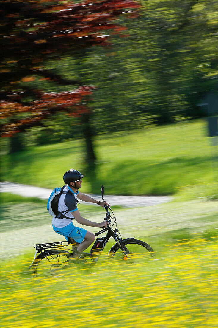 Pedelec cyclist on the way, Upper Bavaria, Germany