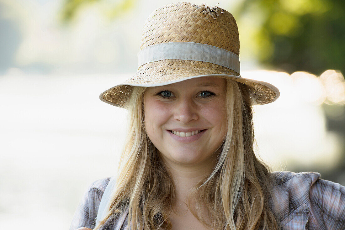 Young woman wearing a strawhat, Rheinfelden, Baden-Wurttemberg, Germany