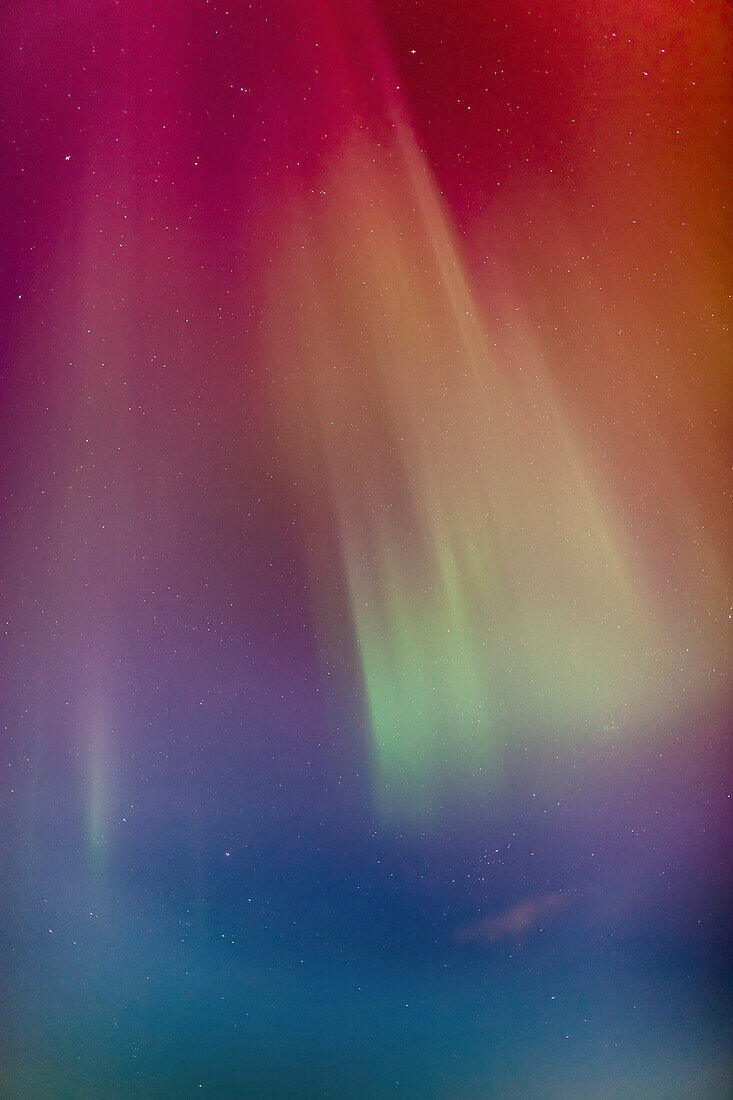 A green and red Northern Lights Corona in the sky above the Tony Knowles Coastal Trail, Winter, Anchorage, Southcentral Alaska, USA.