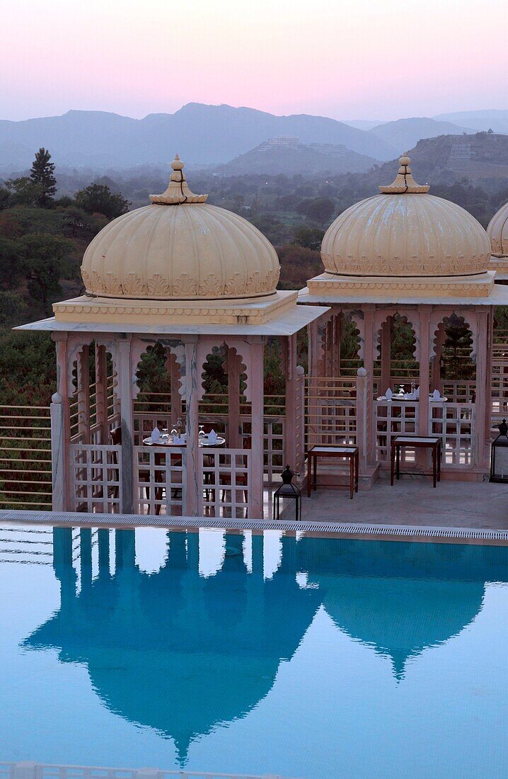 Swimming pool with rooftop pavilions for dining in a hotel, Udaipur, Rajasthan, India