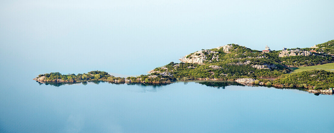 Small island with a church in the middle of the lake, Murici, Lake Skadar National Park, Montenegro, Western Balkan, Europe