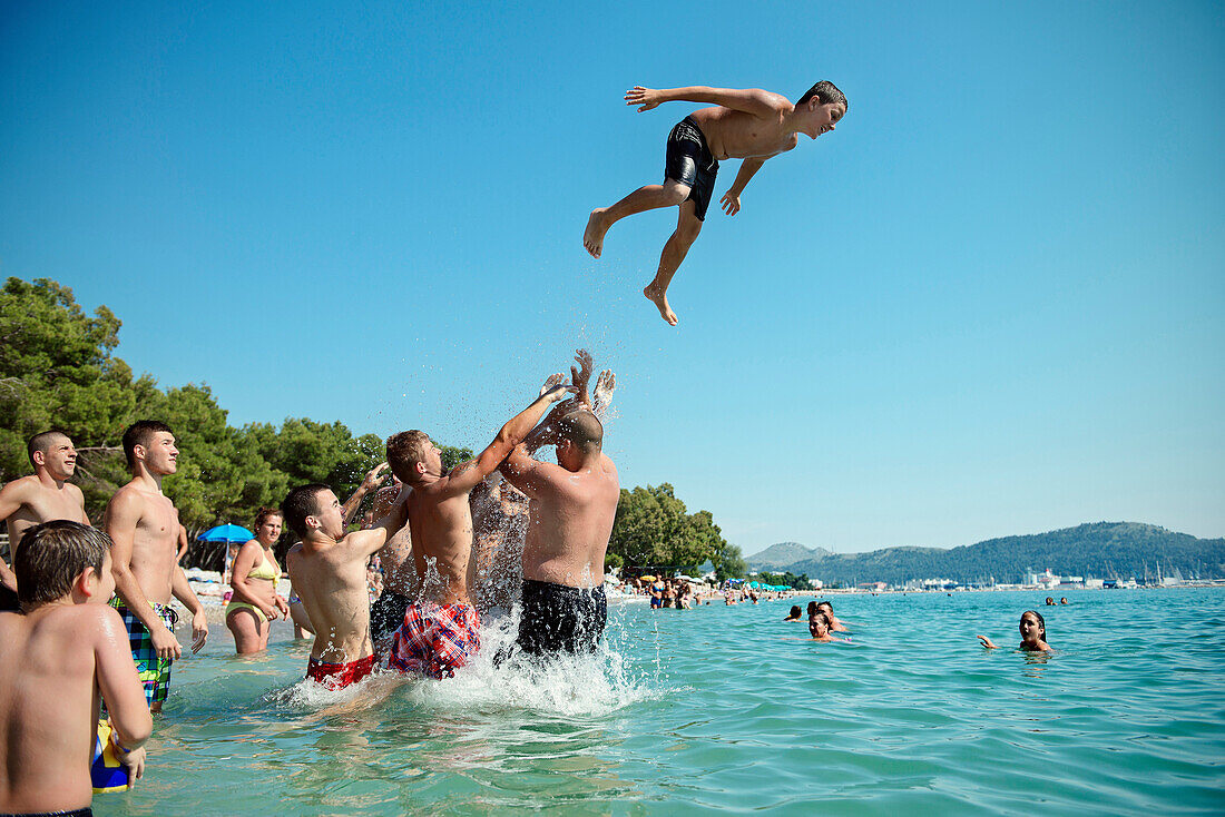 Young people splashing around in the sea, beach at Bar, Adriatic coastline, Montenegro, Western Balkan, Europe