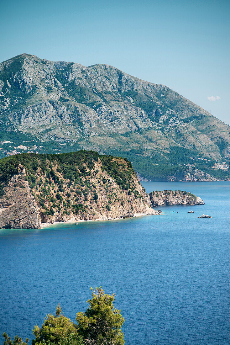 View towards the island of St Nicholas with mountains, Budva, Adriatic coastline, Montenegro, Western Balkan, Europe