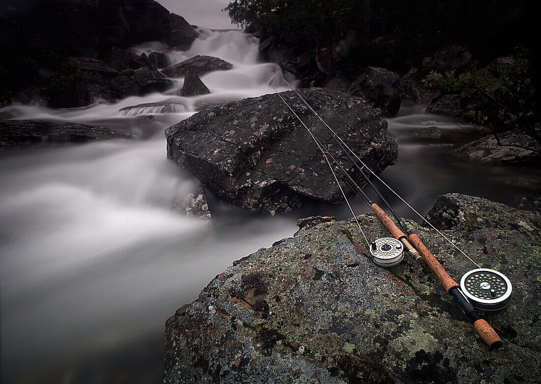 Fishing rod on rock by river, Miekak, Lapland, Sweden