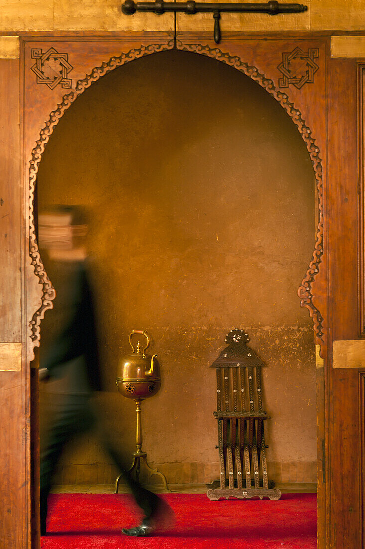 Waiter walking past doorway in Dar Ahlam hotel, Skoura, Morocco