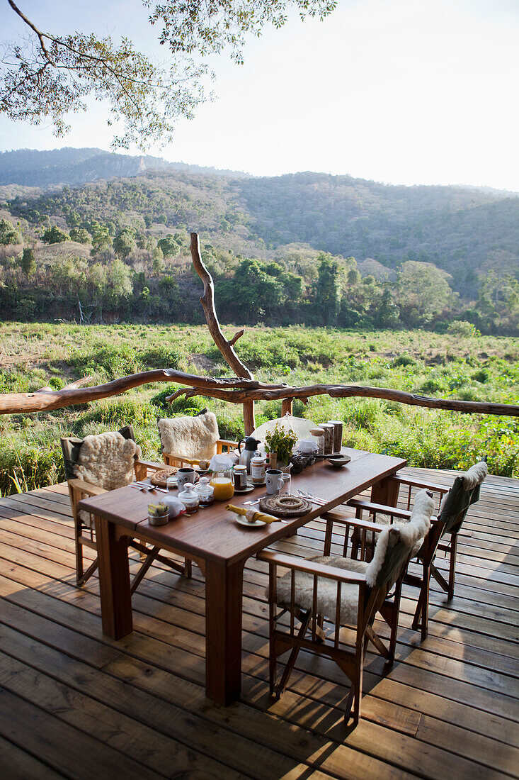 Breakfast table set up on porch at Kitich Safari Camp, Mathews Mountain Range, Kenya