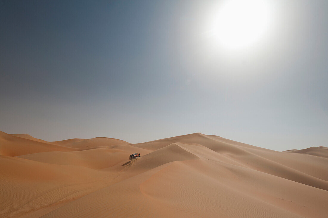 Four wheel drive going across sand dunes, Liwa, Abu Dhabi, UAE