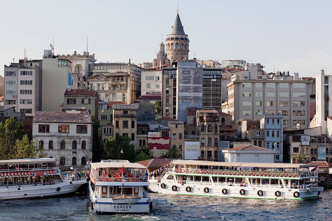 Turkey, Galata Tower in background, Istanbul, Boats alongside of fish market