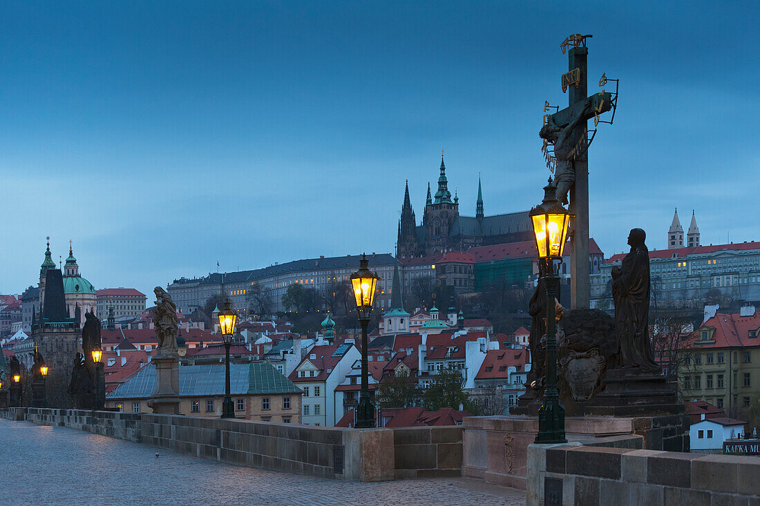 Sculpture depicting Crucifixion of Christ with cityscape in background, Prague, Czech Republic