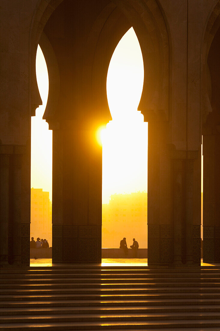 Looking through arches of Hassan II Mosque at dusk, Casablanca, Morocco