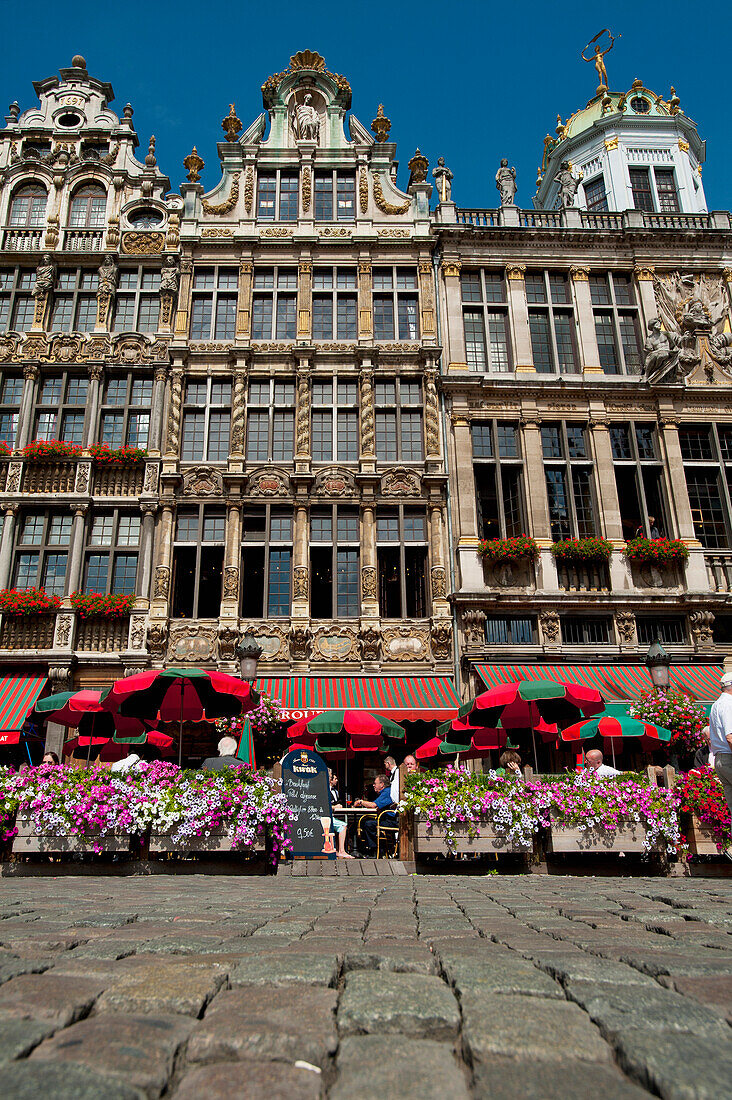 People eating and drinking in outside cafes in Grand Place, Brussels, Belgium