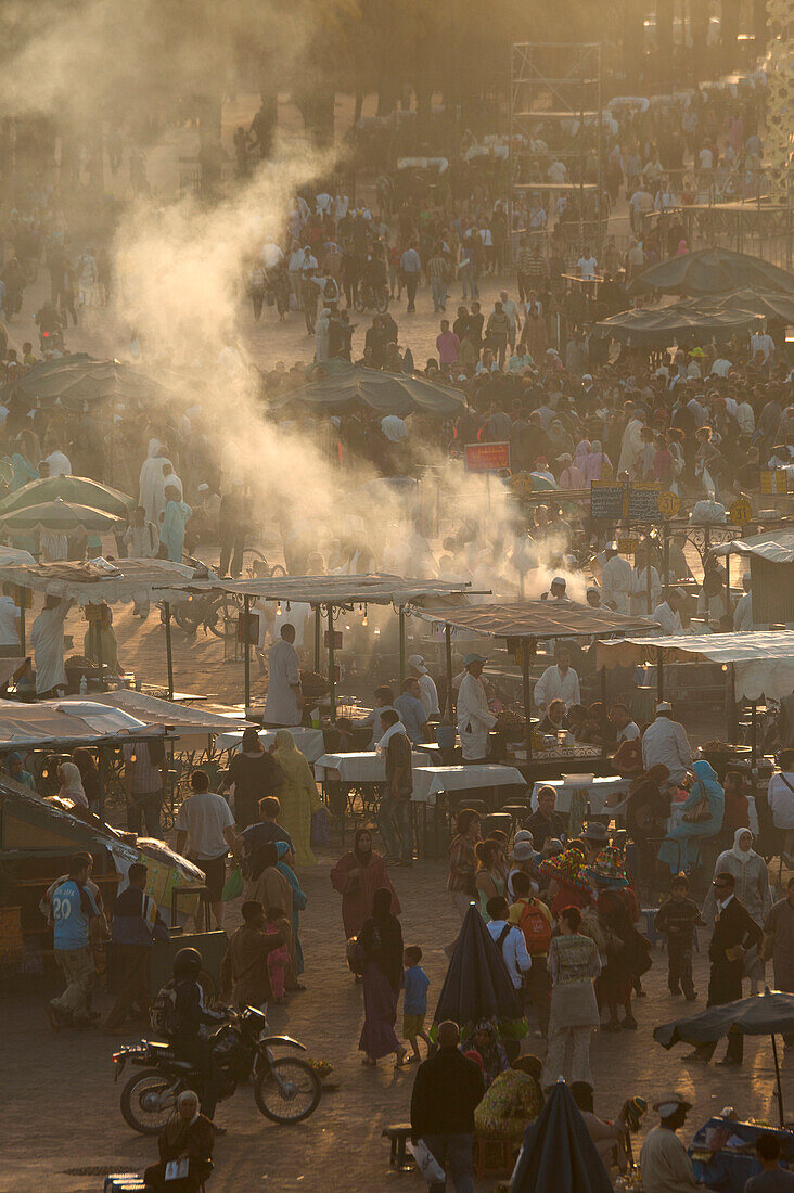 People and food stalls in Djemaa el Fna at dusk, Marrakesh, Morocco
