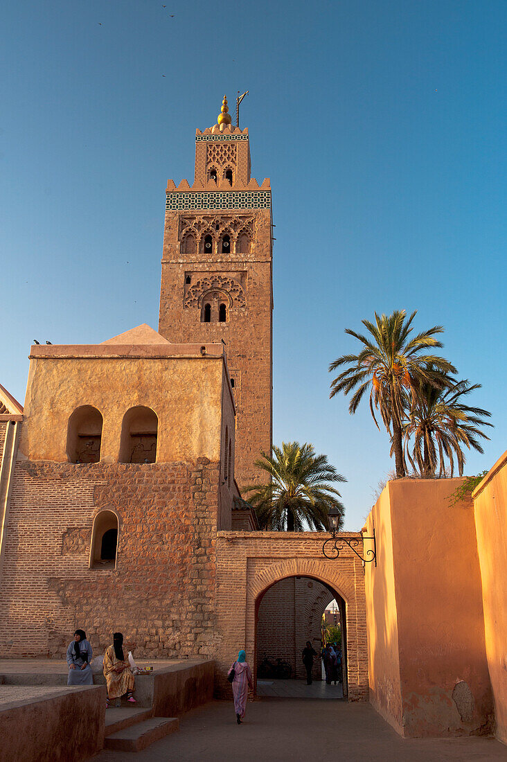 People beside Koutoubia Mosque at dawn, Marrakesh, Morocco