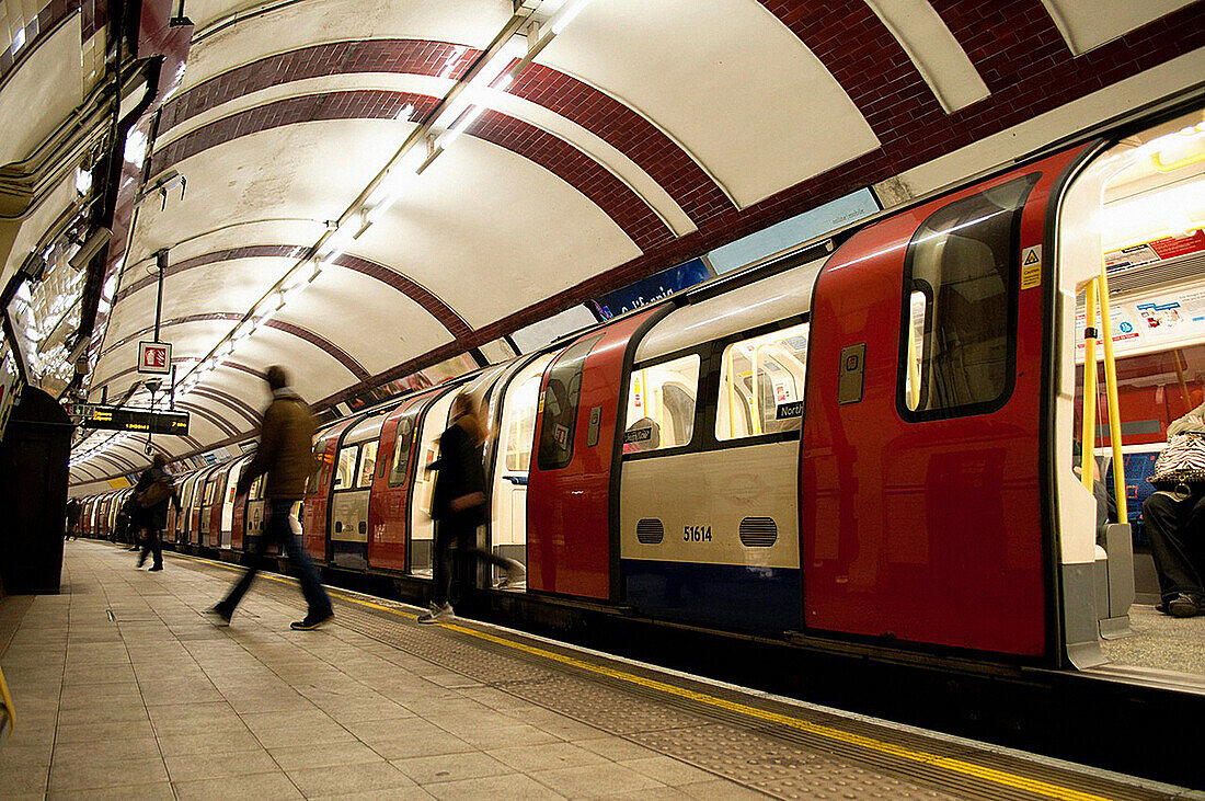 People getting off the train in underground station, London, UK