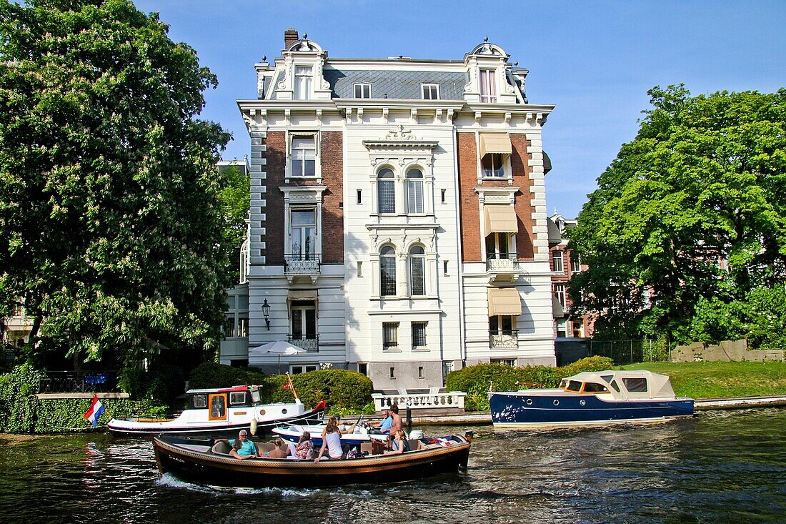 Boats in front of an old town house on the Stadhouderskade, Amsterdam, Holland