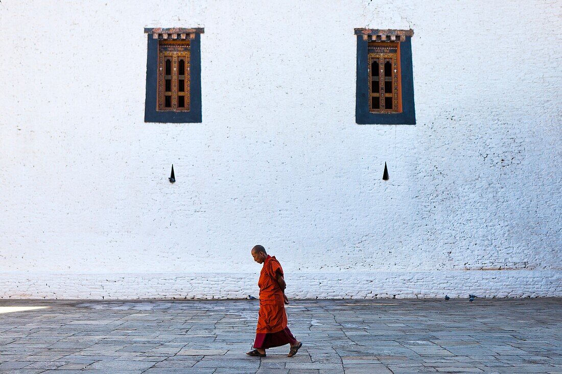 Monk walking inside Punakha Dzong, Punakha, Bhutan, Asia.
