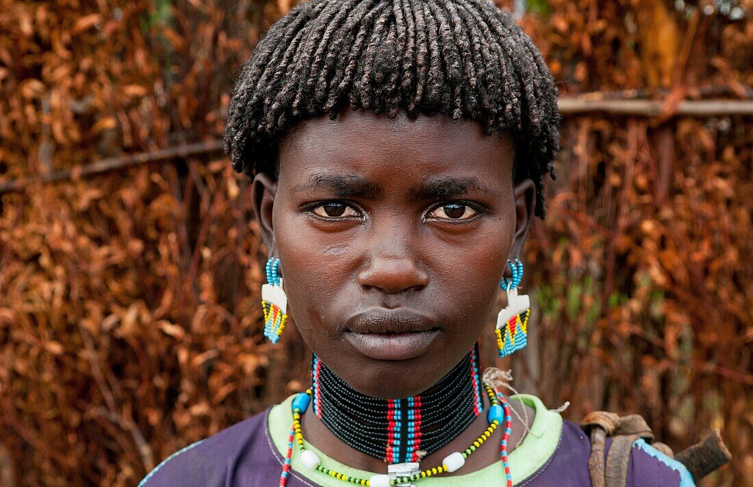Key Afer Ethiopia Africa village Lower Omo Valley portrait closeup of Bena tribe woman with beads and traditional outfits 14