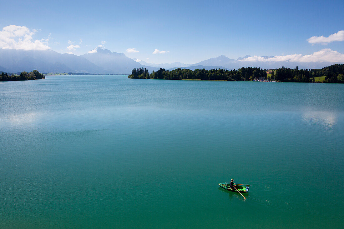 Canoe on lake Forggensee, Allgaeu Alps with Tegelberg, Saeuling and Tannheim mountains in the background, Allgaeu, Bavaria, Germany