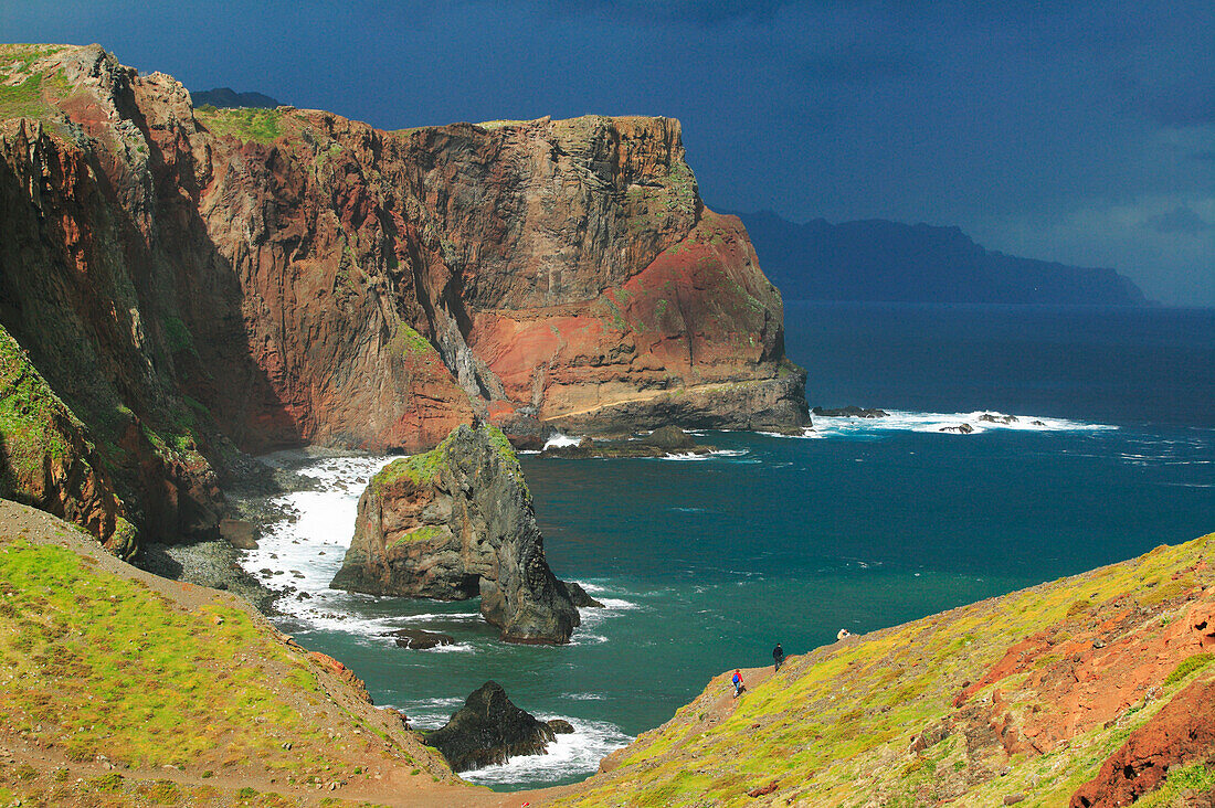 Tourists walking along rocky cliffs in the Ponta de Sao Lourenco Nature Reserve, Madeira