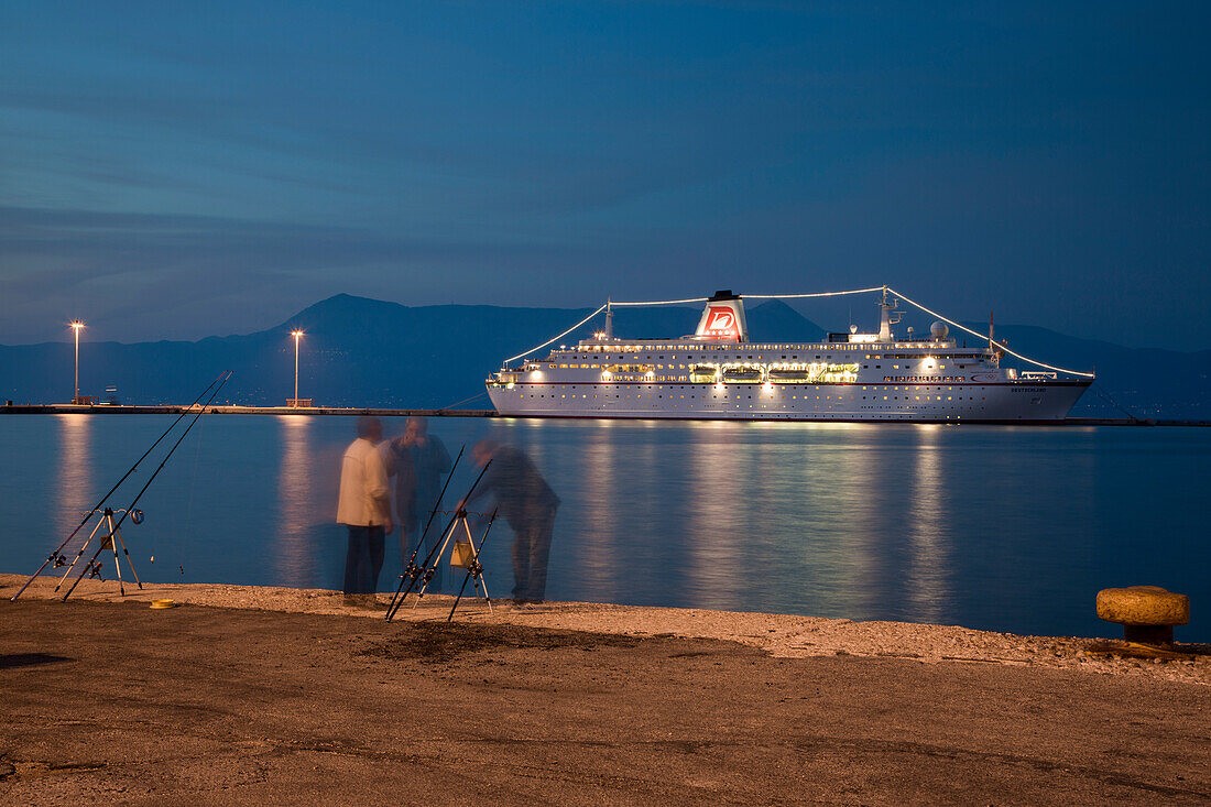 Fishermen at the pier with cruise ship MS Deutschland, Reederei Peter Deilmann in the background, at dusk, Kerkyra, Corfu Town, Corfu, Ionian Islands, Greece