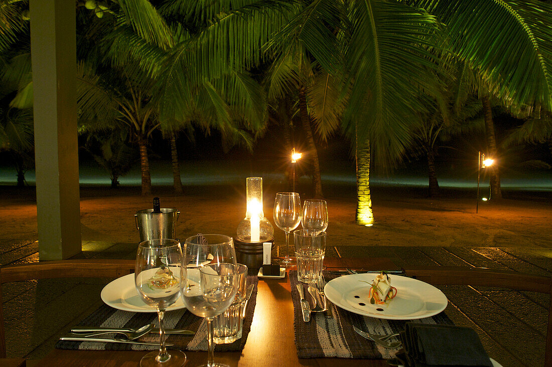 Candlelight dinner on the beach with palm trees at Hotel Jetwing Blue, Negombo, Sri Lanka