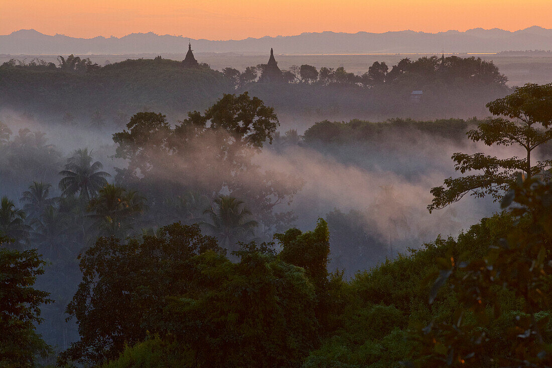 View above hill the hills and pagodas in the evening mist at Mrauk U, Myohaung north of Sittwe, Akyab, Rakhaing State, Arakan, Myanmar, Burma
