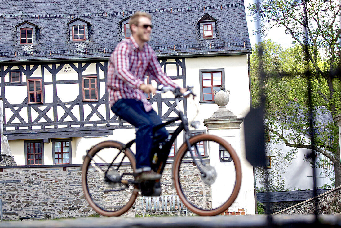Man riding an electric bicycle, Tanna, Thuringia, Germany