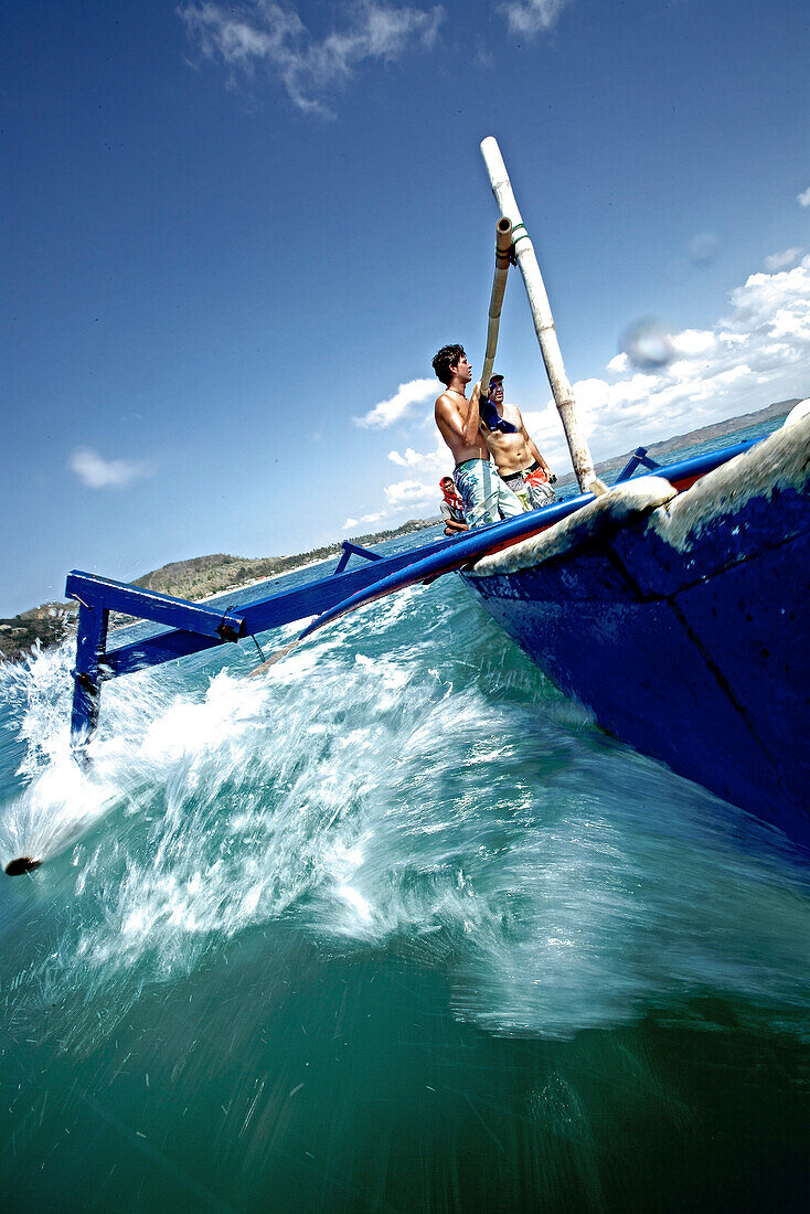 Three men in a boat, Denpasar, Bali, Indonesia