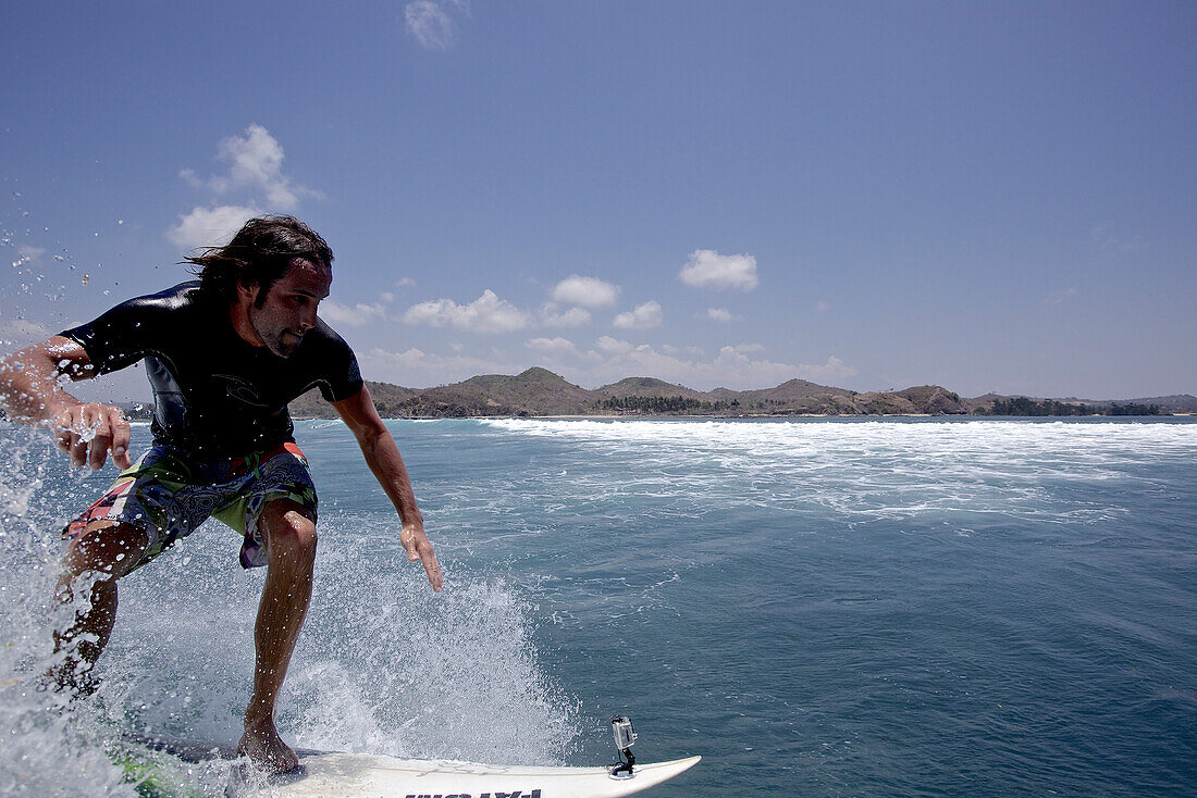 Surfer riding a wave, Jakarta, Java, Indonesia