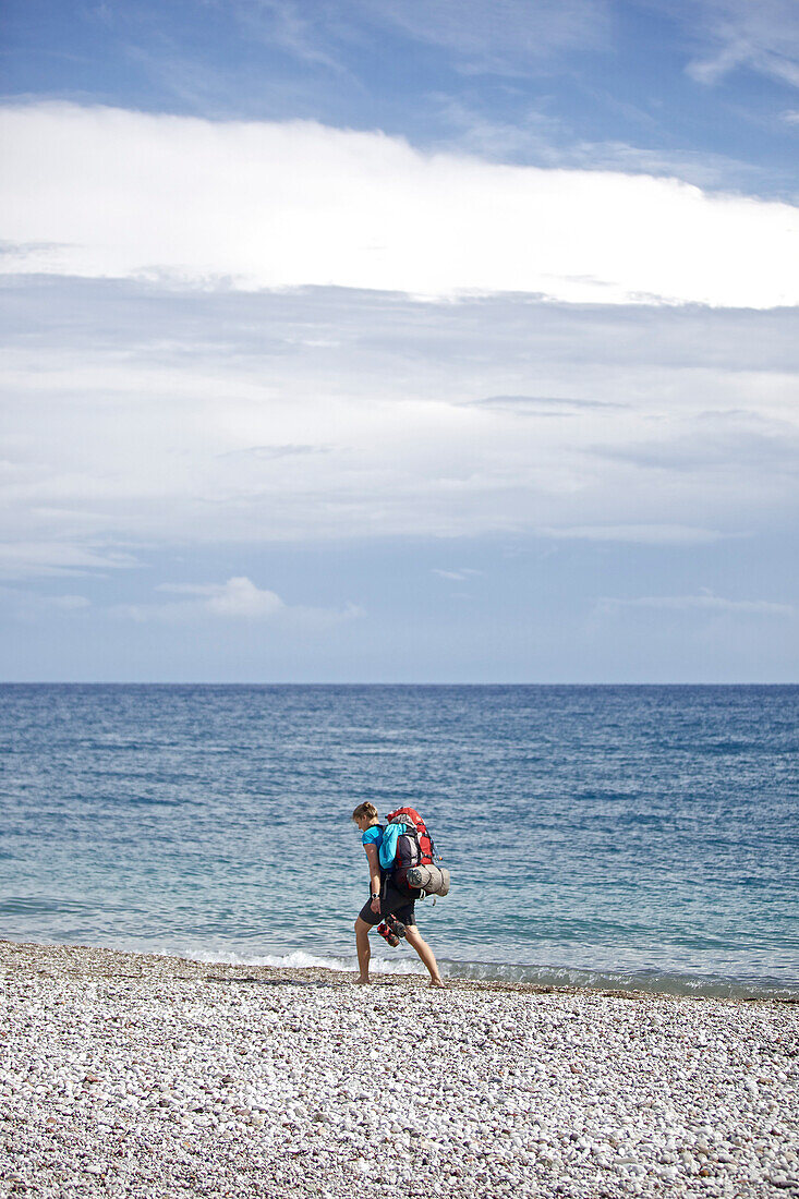 Woman hiking along long-distance footpath Lycian Way, Antalya, Turkey