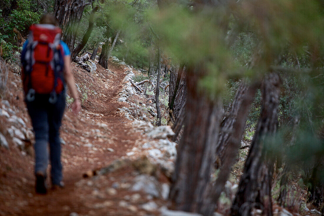 Woman hiking along long-distance footpath Lycian Way, Antalya, Turkey
