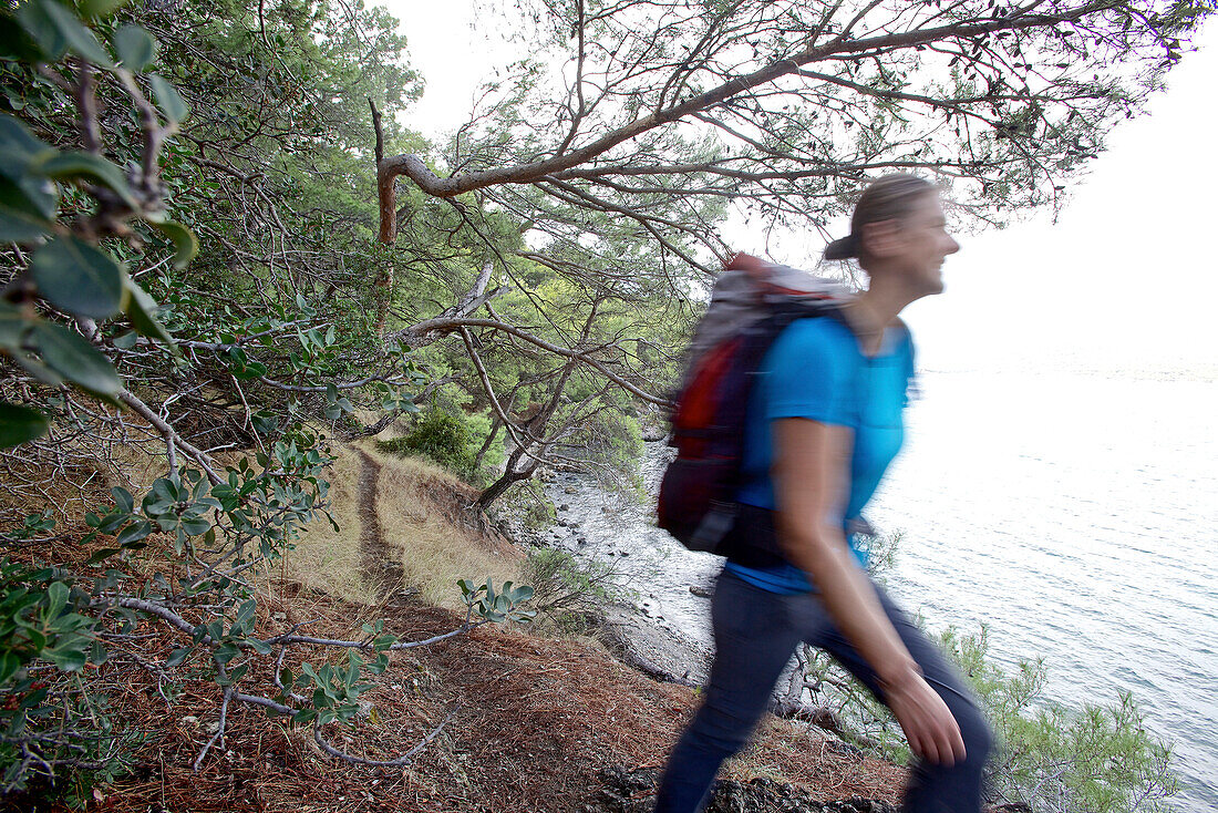 Woman hiking along long-distance footpath Lycian Way, Antalya, Turkey