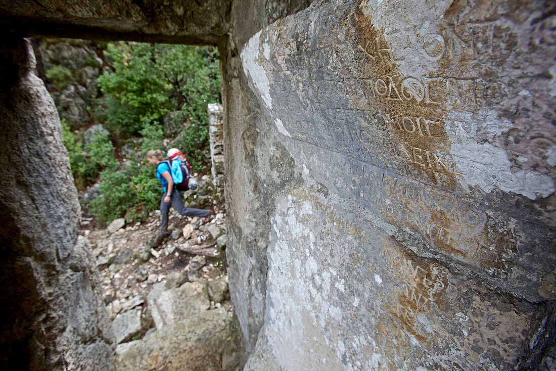 Woman hiking along long-distance footpath Lycian Way, Antalya, Turkey