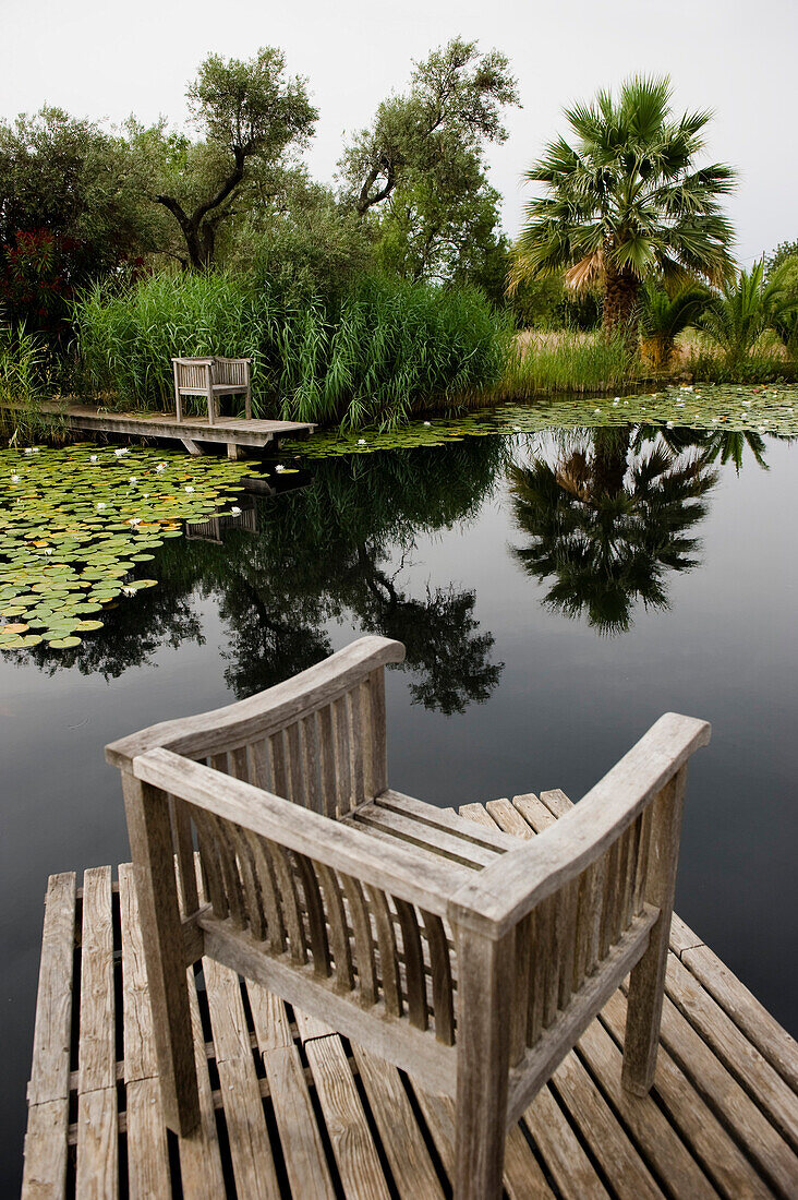 Chairs at a water lily pond, Algarve, Portugal