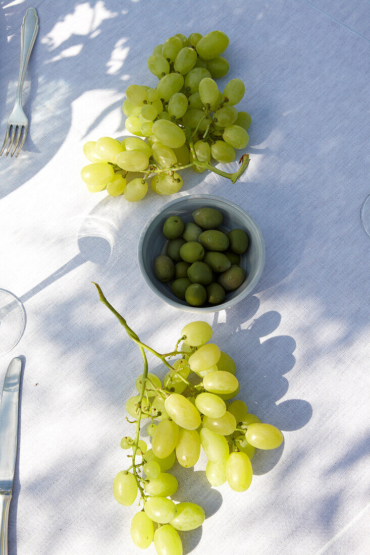 Grapes and olives on the table, Masseria, Alchimia, Apulia, Italy