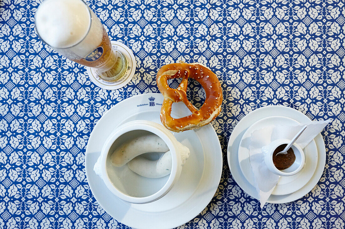 Traditional Bavarian sausage breakfast, Weisswurst with pretzel and weissbier, Hofbraeuhaus Muenchen, Munich, bavaria, Germany