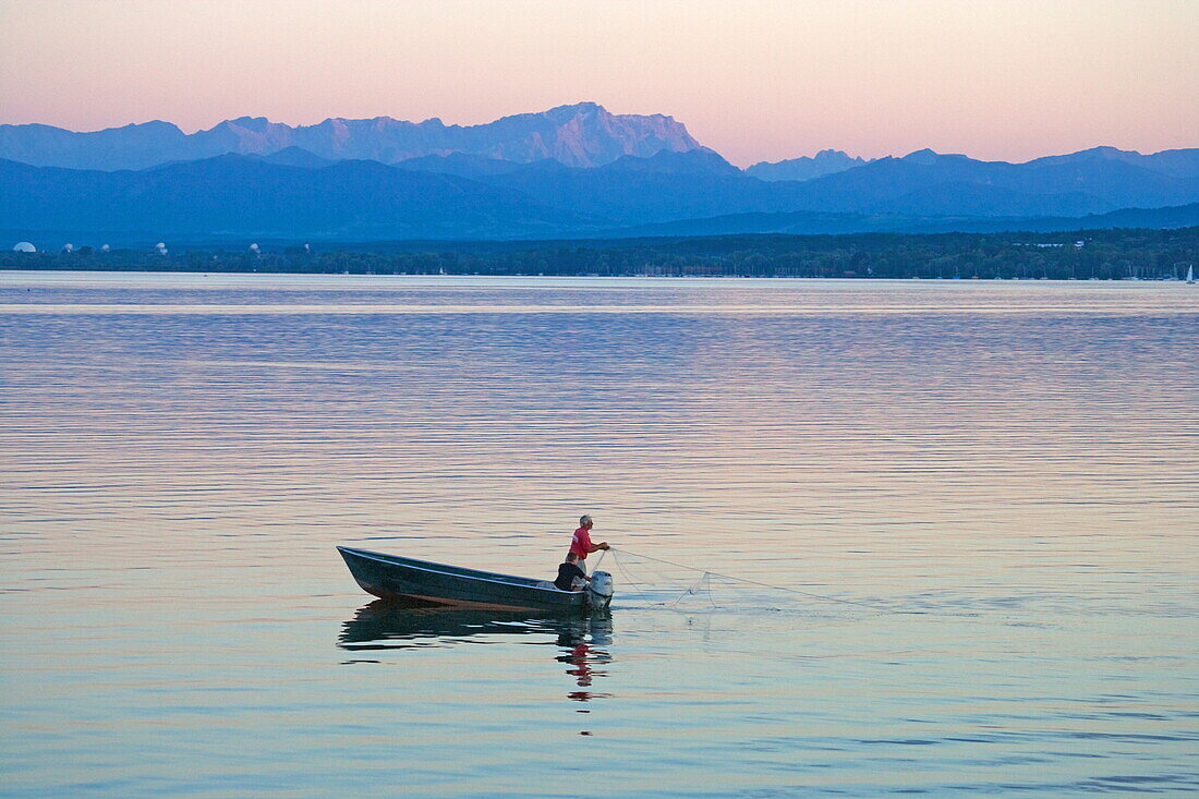 Fisherman with Zugspitze in the background, Ammersee, Upper Bavaria, Bavaria, Germany