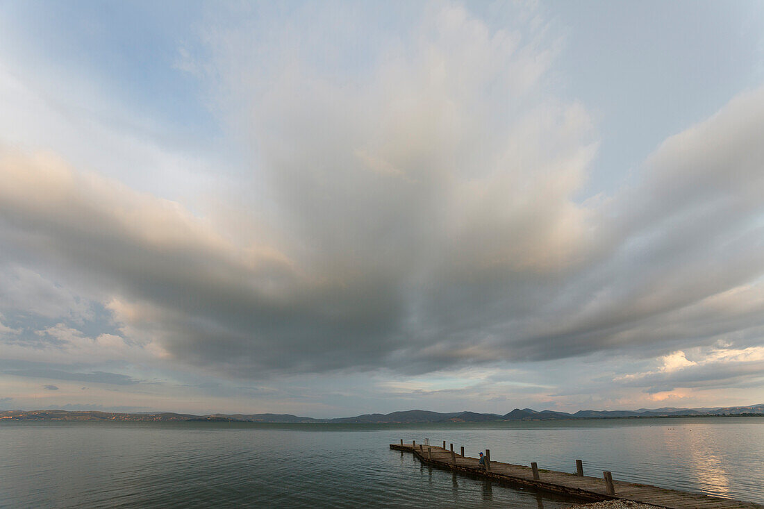 Jetty at the lake shore, clouds, Castiglione del Lago, Lago Trasimeno, province of Perugia, Umbria, Italy, Europe