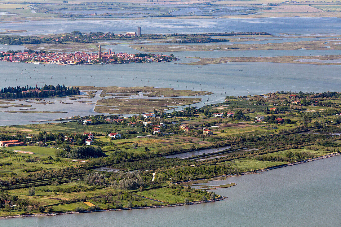 Aerial view of islands in the Venetian lagoon, Island of Sant' Erasmo with Burano and Torcello in the background, Veneto, Italy
