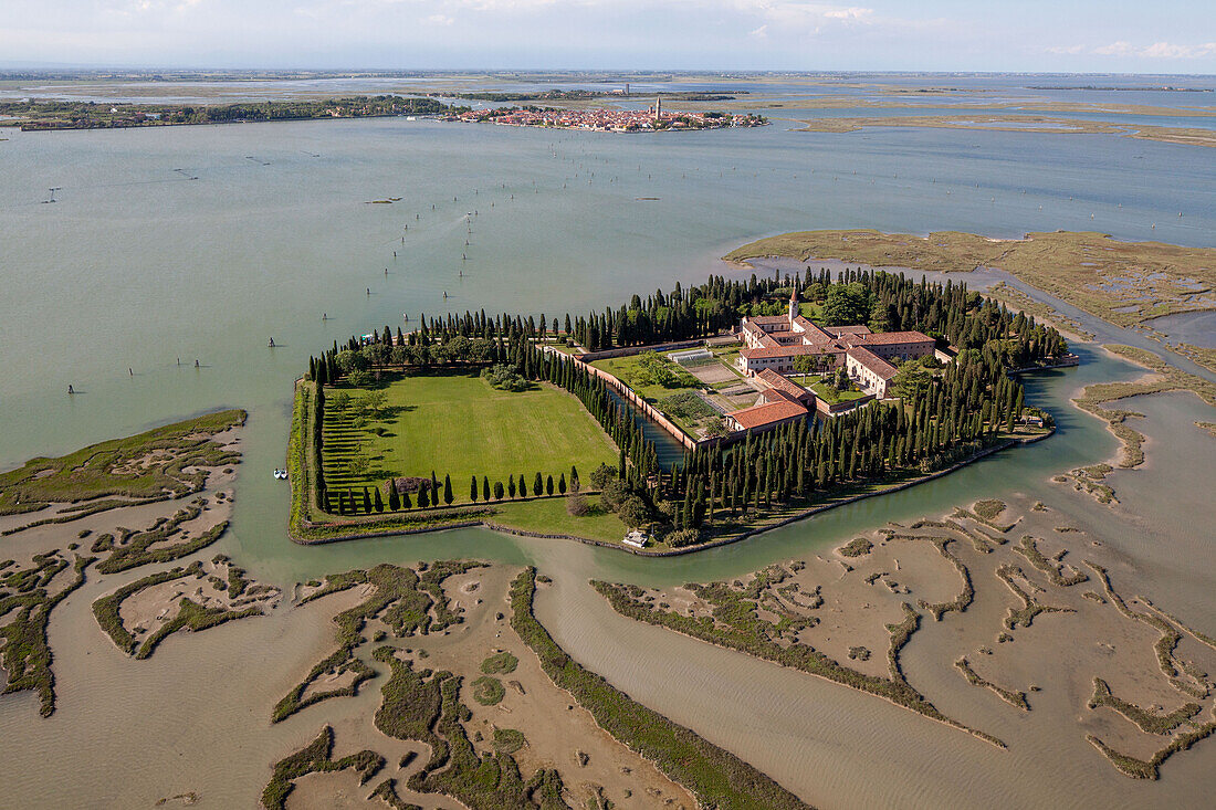 Aerial view of islands in the Venetian lagoon, Island of San Francesco del deserto with salt marshes, Burano in the background, Veneto, Italy