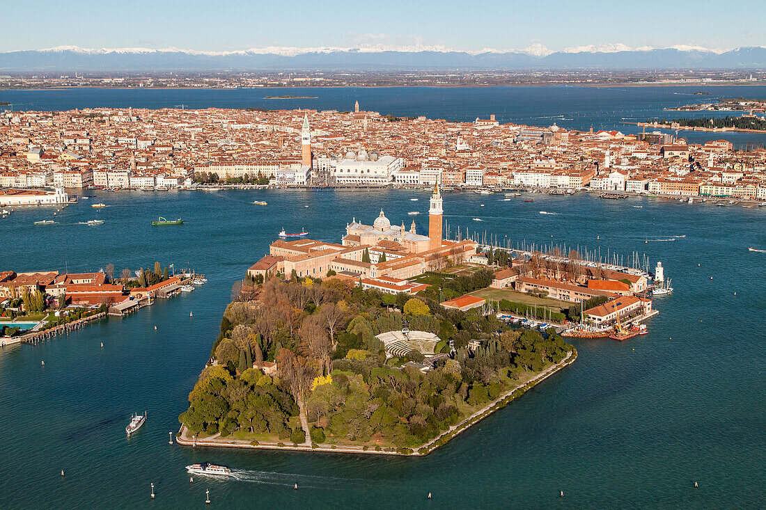 Aerial view of venice with Giudecca and San Giorgio Maggiore, Campanile di San marco, snow-capped mountains of the Alps in the background, Venice, Veneto, Italy