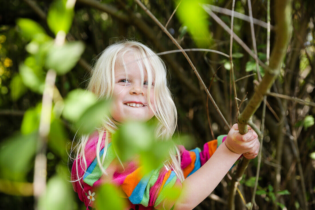 Girl (4 years) playing in a forest, Goseck, Saxony-Anhalt, Germany