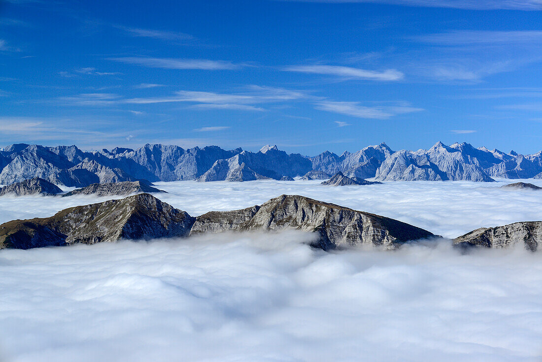 View to Unnuetz and Karwendel range with sea of fog in the valley, Guffert, Rofan range, Tyrol, Austria