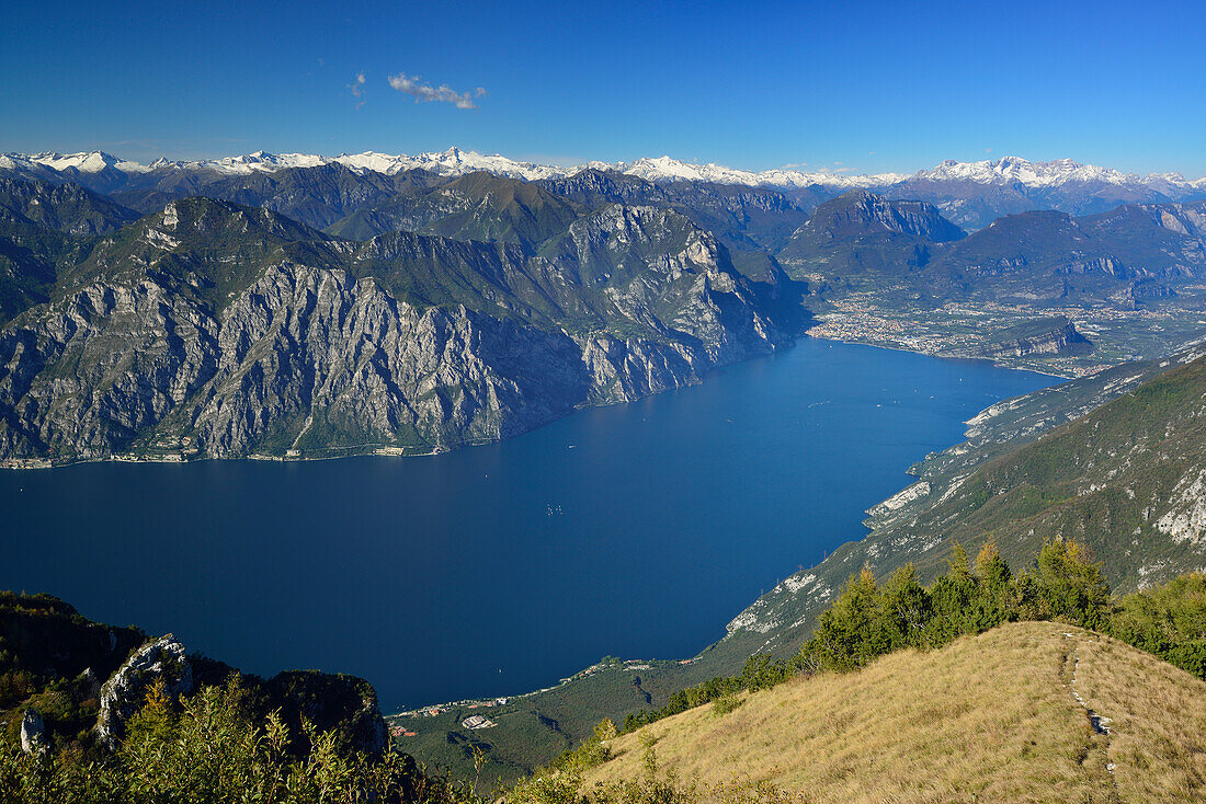 Lake Garda with Riva and view to Lake Garda range, Adamello range, Presanella range, Brenta range and valley of Sarca, Ventrar, Monte Baldo, Lake Garda range, Trentino, Italy