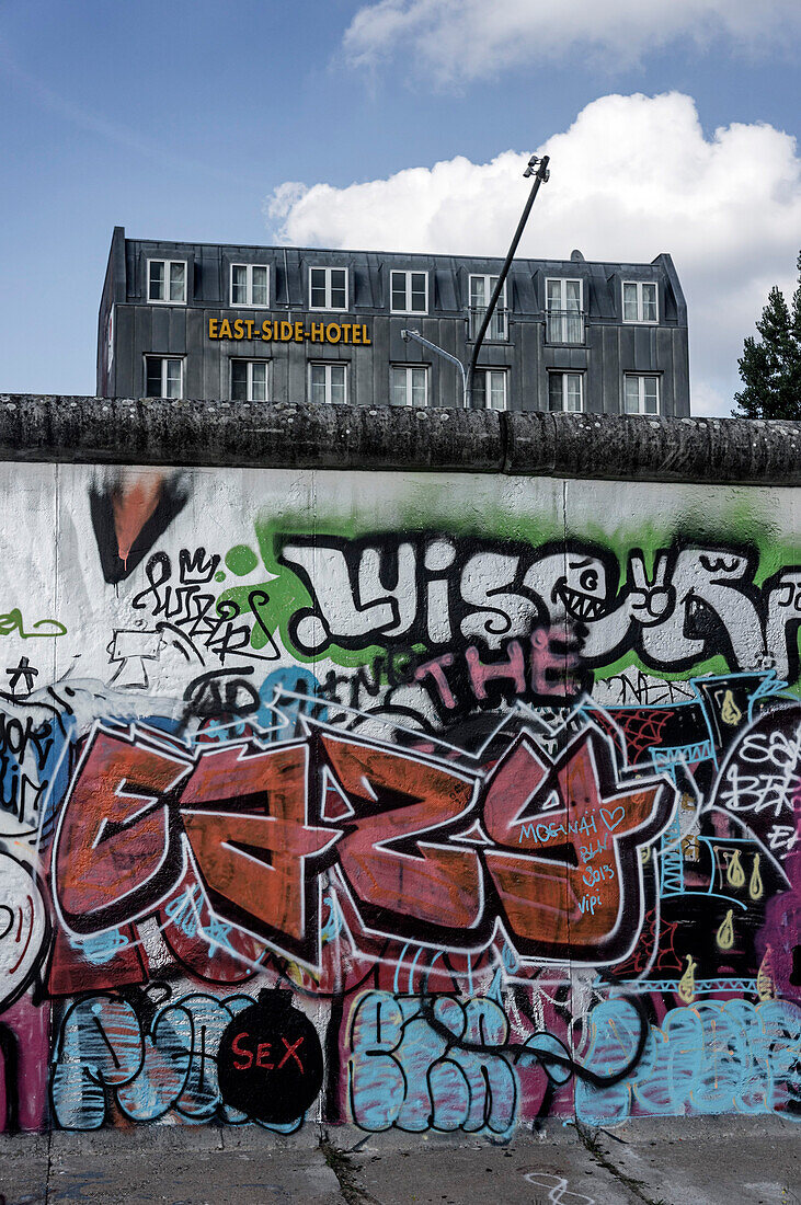 Berlin Wall with graffiti and East Side Hotel, Friedrichshain, Berlin, Germany