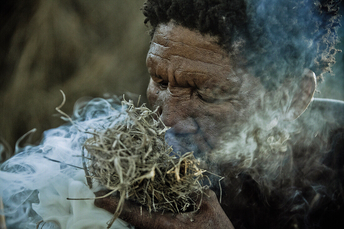 A man of the San tribe igniting a fire, Otjozondjupa region, Namibia, Africa